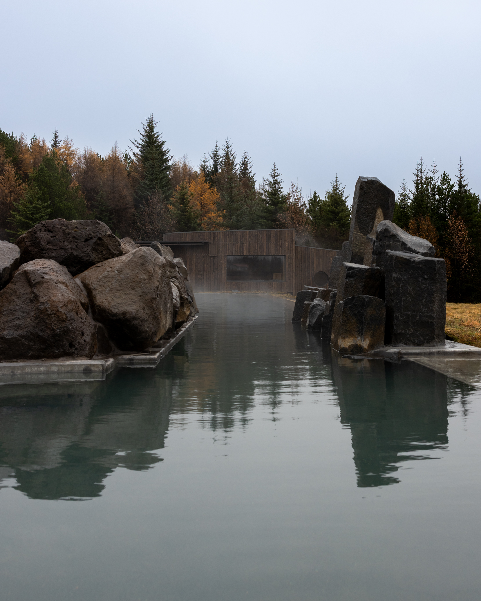 A geothermal lagoon with a turf-roofed building